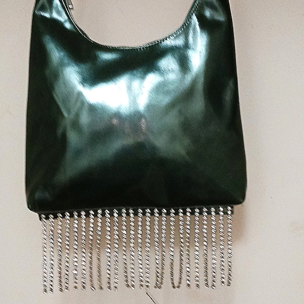 Purse with shoulder strap and rhinestone detail along bottom.